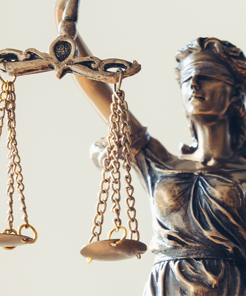 Statue of Lady Justice holding balanced scales, symbolizing fairness and the law.
